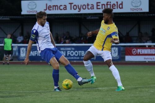 Enfields Remi Sutton (L) and Stortfords Damien Green
