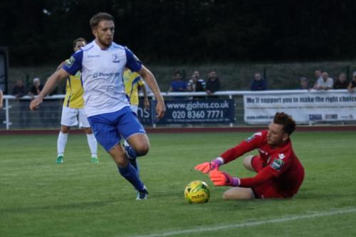 Enfields Remi Sutton is beaten to the ball by Stortford keeper Calum Kitscha
