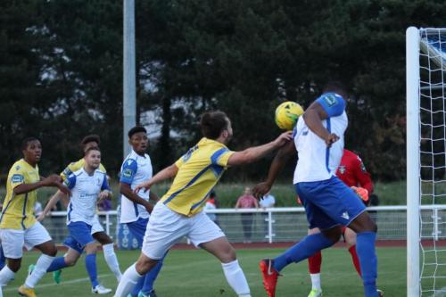 Enfields Taofiq Olomowewe (R) heads the ball back into the six-yard box