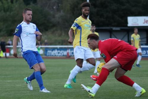 Stortford keeper Calum Kitscha collects ahead of Liam Hope (L) and Damien Green