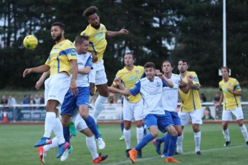 Stortfords Damien Green (yellow, 2nd L) heads clear