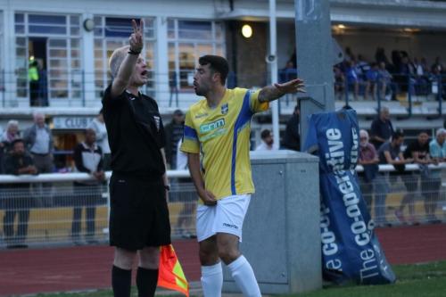 Stortfords Sam Robbins discusses the second Enfield goal with the referees assistant