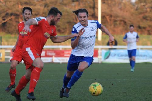 Enfields Sam Youngs (R) runs at Josh Vincent