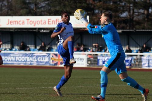 Folkestone keeper Tim Roberts collects ahead of Karl Oliyide