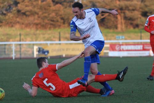 Folkestones Callum Davies (5) challenges Matt Johnson
