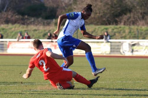 Folkestones Josh Vincent (2) just beats Karl Oliyide to a through ball