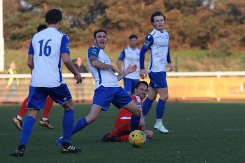 Folkestones Michael Everitt (red) challenges Matt Johnson