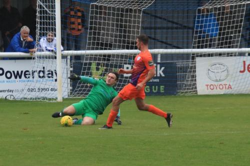 Enfield keeper Joe Wright tackles Harley Haag on the edge of the penalty area