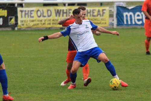 Enfields Brandon Adams shields the ball from Jack Devaney