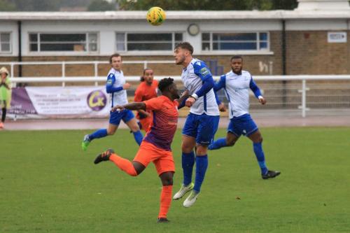 Enfields Dan Rumens heads clear from Albert Adu