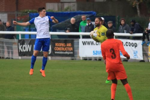 Enfields Josh Davison (L) makes a token jump as Harry Ricketts collects the ball