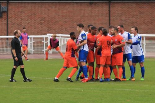 Referee James Simpson keeprs a close eye on the jostling at a corner kick