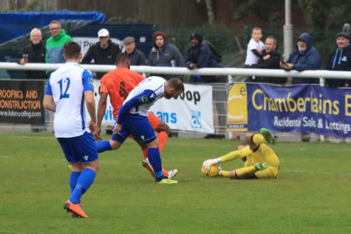 Ware keeper Harry Ricketts smothers the ball as Junior Brown (4) holds off Billy Bricknell
