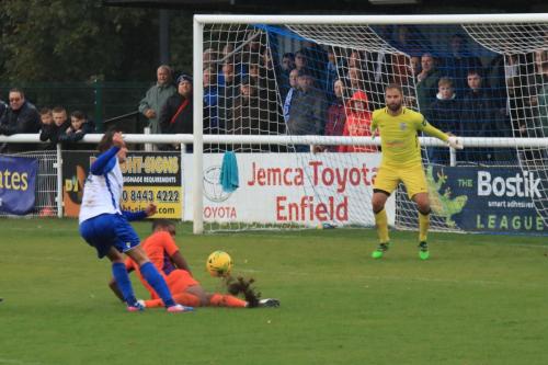 Wares Bradley Frasier (orange) blocks a shot from Sam youngs