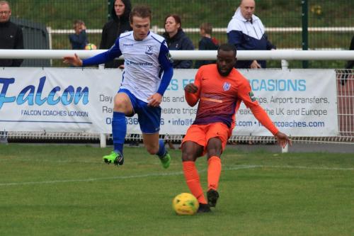 Wares Dom Njoya (R) clears under pressure from Mickey Parcell