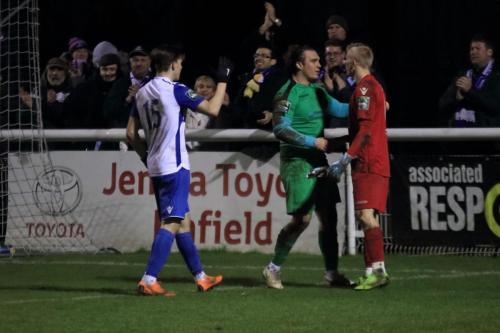 Enfields Josh Davison congratulates his keeper  Joe Wright (green) as Wright consoles his opposite number Arthur Janata