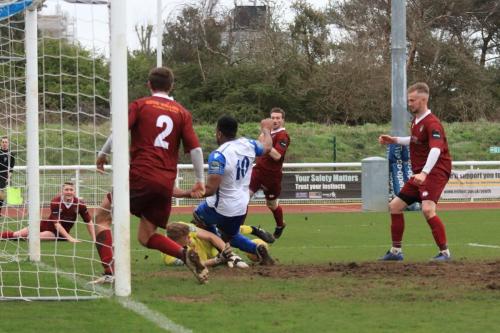Bognor keeper Petar Durin blocks at the feet of Kezie Ibe