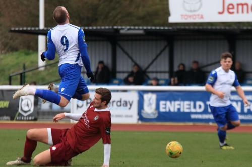 Bognors Ed Sanders (maroon) tackles Billy Bricknell late