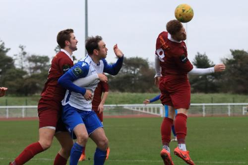 Bognors Theo Widdrington (R) heads clear as Ed Sanders (L) holds onto Matt Johnson