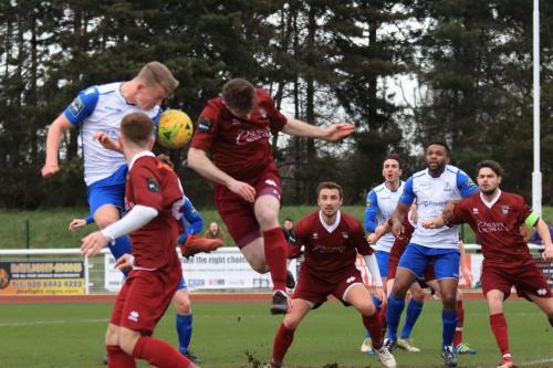 Enfields Joe Payne (white) and Bognors Keaton Wood challenge  for a header