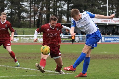 Enfields Joe Payne shoots as Ed  Sanders tries to block