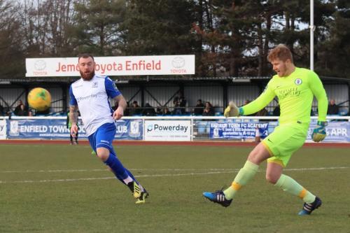 Burgess Hil keeper Josh James clears from Billy Bricknell