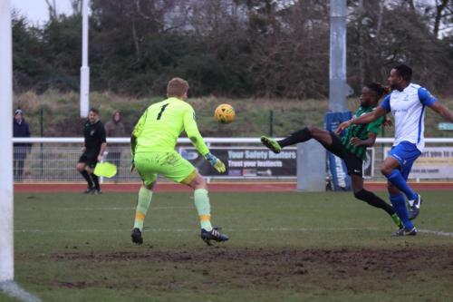 Burgess Hills Boris Kipeya-Bonno (green) knocks the ball away from Kezie Ibe
