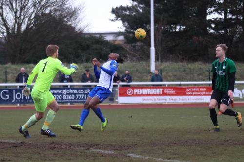 Enfields Karl Oliyde (centre) is beaten by the bounce of the ball