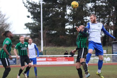 Enfields Sam Hatton (R) gets a header on target