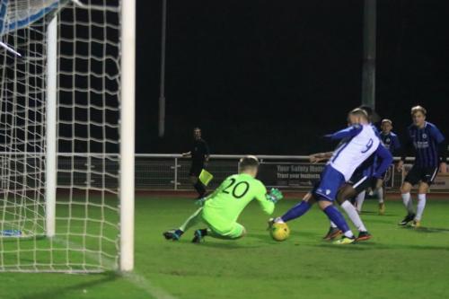 Burgess Hill keeper Mitchell Bromage saves at the feet of Billy Bricknell but the ball runs to Josh Davison for the opening goal