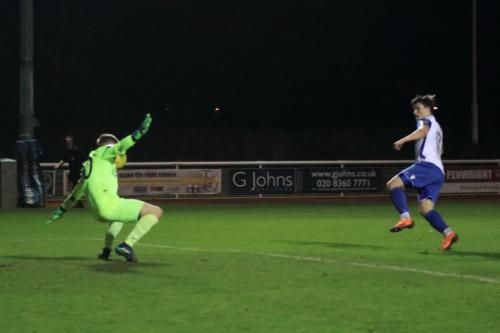 Burgess Hill keeper Mitchell Bromage saves from Josh Davison