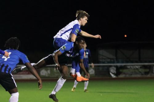 Enfields Josh Davison (white shirt) challenges Tolulope Jonah