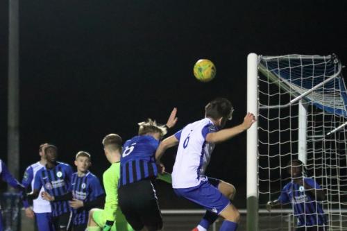 Enfields Remi Sutton (white 6) reaches a corner at the far post but can only head onto the top of the net