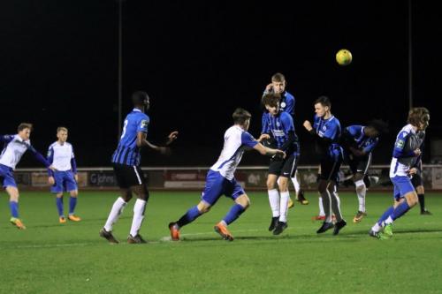 The Burgess Hill wall blocks a free kick from Aaron Greene (L)