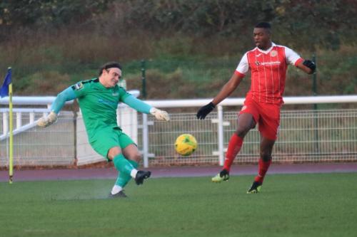 Enfield keeper Joe Wright clears from Emile Acquah