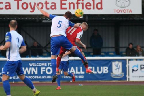 Enfields Marc Weatherstone (5) challenges Christian Scales