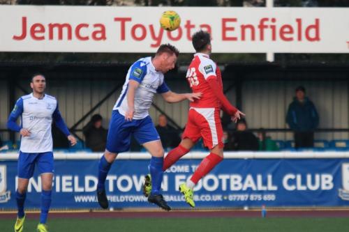 Enfields Marc Weatherstone challenges Tom Hitchock (red)