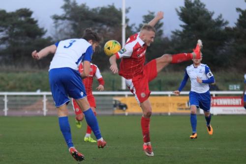 Enfields Remi Sutton (L) challenges Christian Slater