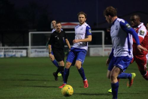 Enfields Remi Sutton (L) plays the ball to Aaron Greene