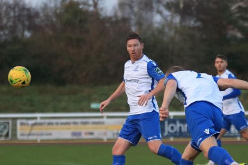 Enfields Sam Hatton (R) heads the ball to his keeper watched by Marc Weatherstone