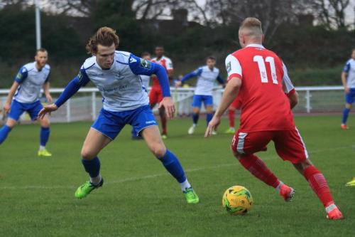 Harlows Christian Scales (R) runs at Mickey Parcell