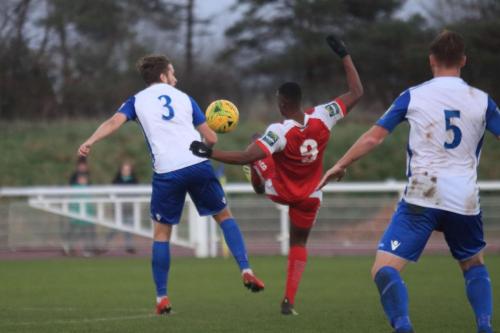 Harlows Emile Acquah (red) challenges Remi Sutton