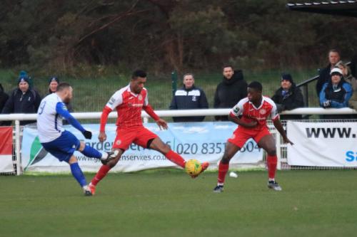 Harlows JJ da Cruz (centre) blocks Billy Bricknells shot