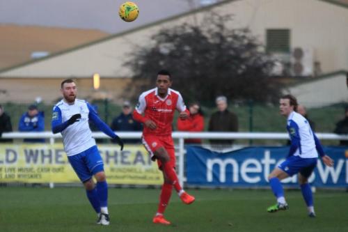 Harlows JJ da Cruz (red) clears from Billy Bricknell