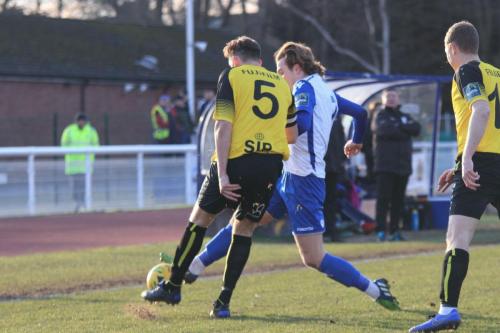 Enfields Mickey Parcell (white) challenges Liam Friend (5)