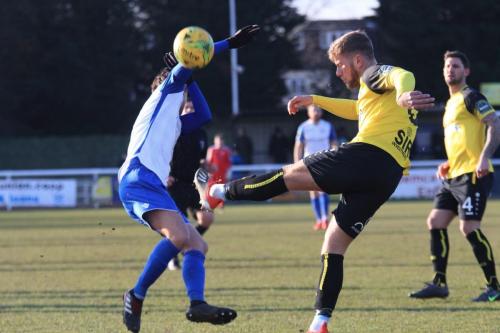 Enfields Sam Youngs (L) tries to block a clearance from Ben Swift