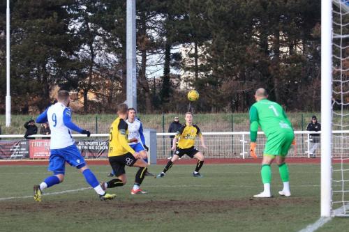 Margates Ben Swift (yellow, L) clears the ball before it can reach Billy Bricknell (9)
