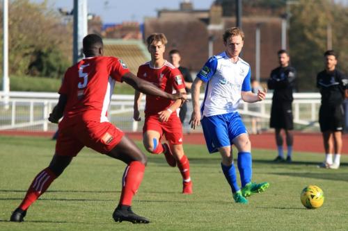 Enfields Aaron Greene (R) plays the ball past Aaron Goode (5) watched by Fintan Walsh