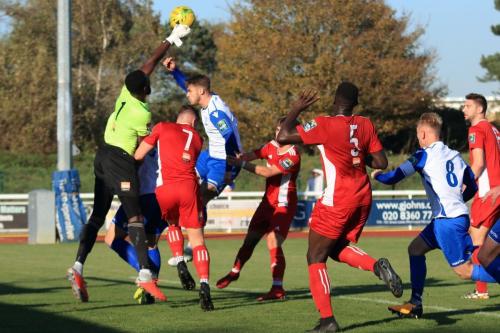 Whitehawk keeper Melvin Minter punches clear from Dan Rumens
