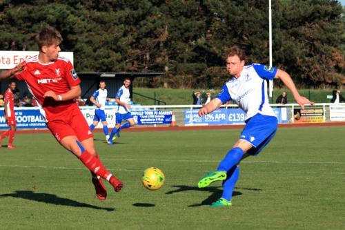 Whitehawks Fintan Walsh (L) blocks a shot from Aaron Greene